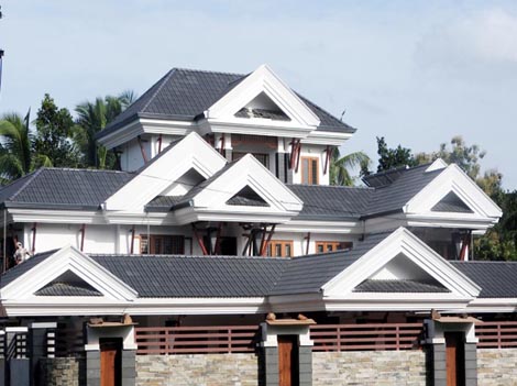 Close-up of two carpenters discussing the work on top of an unfinished roof